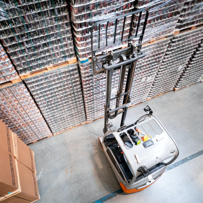 Forklift in warehouse at work, above view